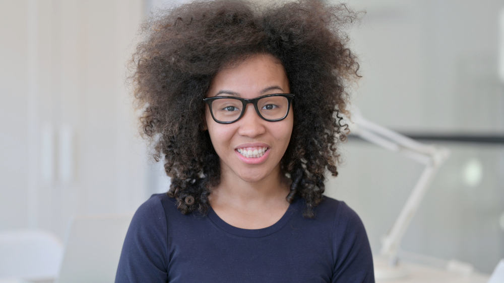 A curious lady wearing a shaggy cut on curly long hair, which is all the rage on social media right now.