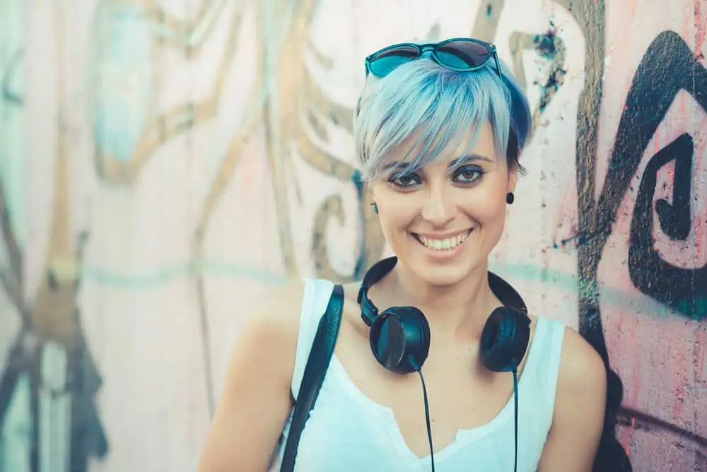 The Best Blue Hair Dyes for Dark Hair Plus Alternatives 1 Young beautiful female with a pale skin tone wearing permanent blue hair dye on light brown hair.
