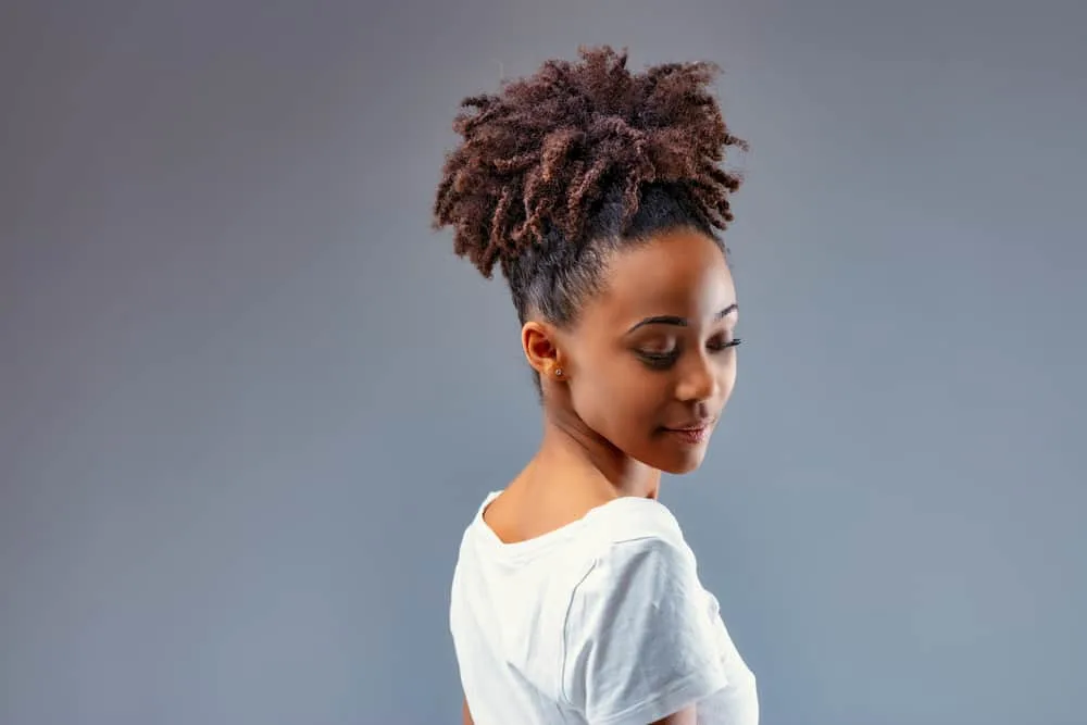 Can You Use Toner Without Developer? Best Toners on the Market 6 Stylist young woman with light brown tips after bleaching hair with Splat and using a green toner on her curly long hair.