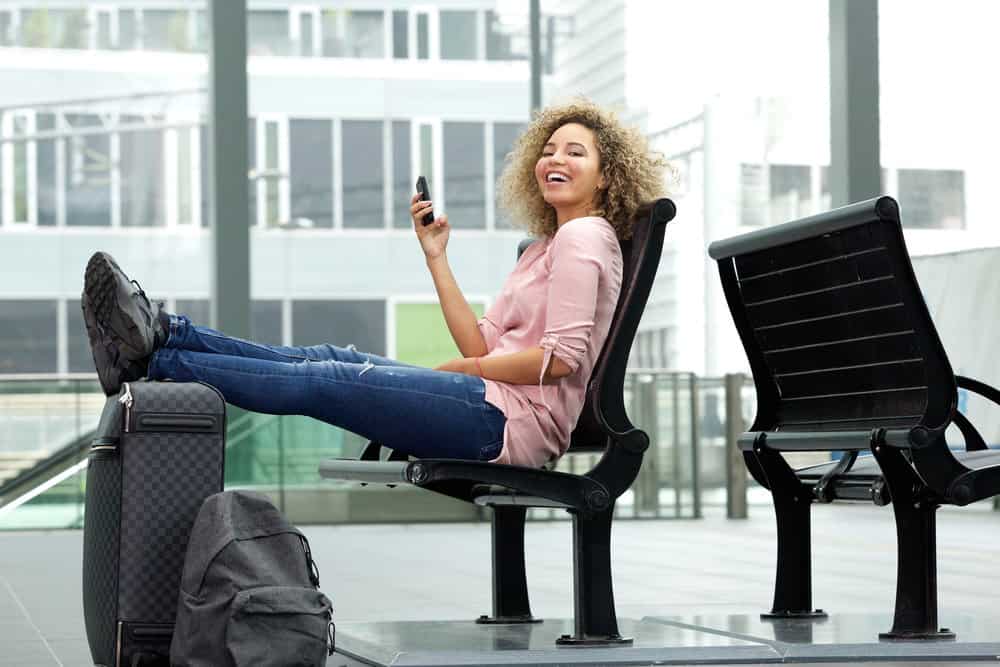 A black female with electric hair clippers and hair attachments in her carry-on luggage.