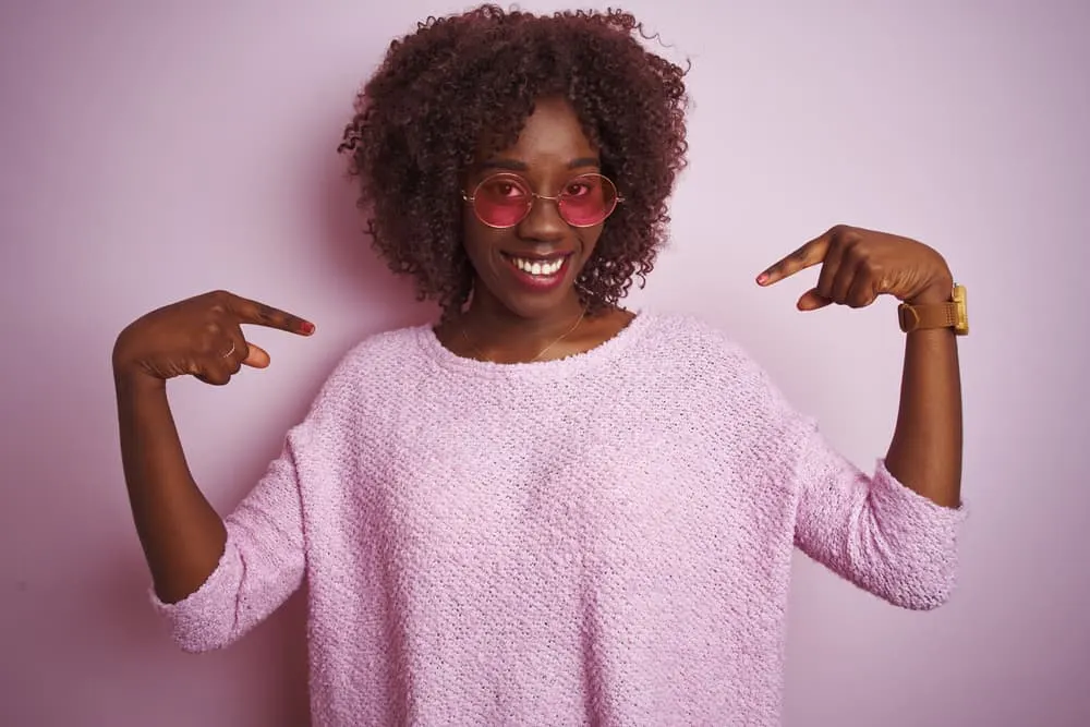 Weaves vs Wigs Debated: Which Is Better a Wig or Weave? 6 African American lady covering her real hair with a weave sewn to cornrows to grow-out damaged hair.