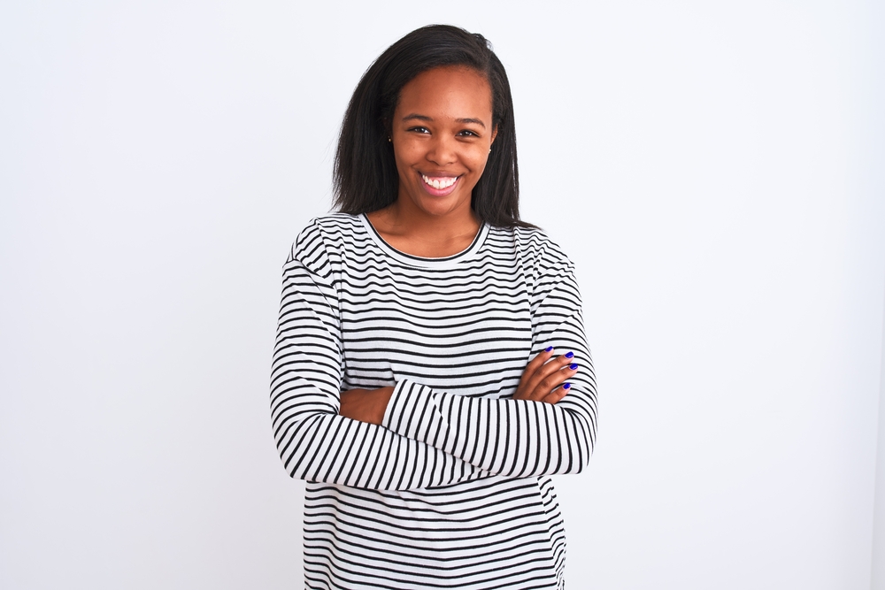 African American female with healthy hair after using a hair straightener and heat protectant on her thick hair.