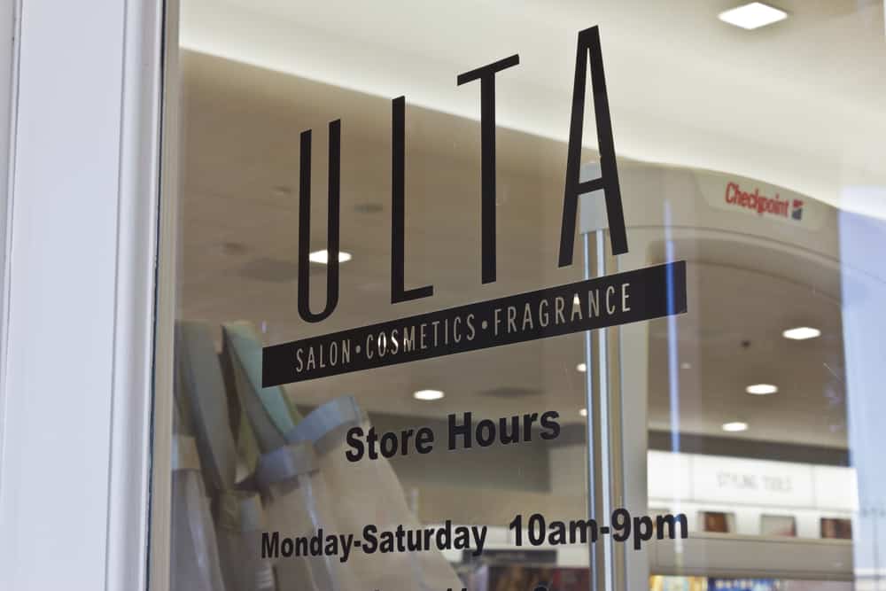 Ulta store hours on the storefront window - where you can get everything from haircuts to demi-permanent hair color.