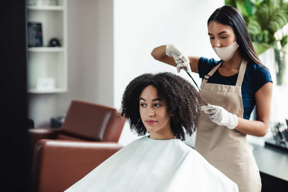 Light-skinned black women in a Walmart hair salon getting an express haircut and deep conditioning treatments.
