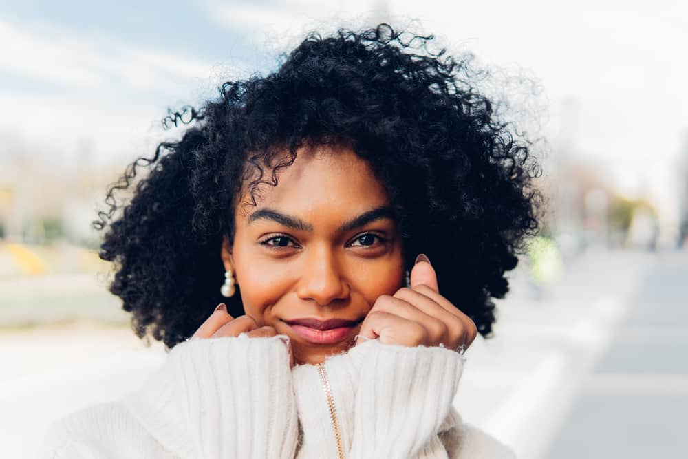 African American female with light brown skin color and dark hair after dyeing her dark brown with jet black hair dye.