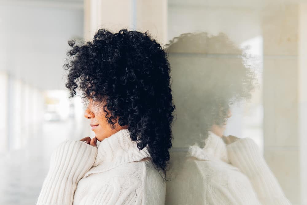 Relaxed young black woman after a dramatic change - dyeing hair black by a professional colorist.