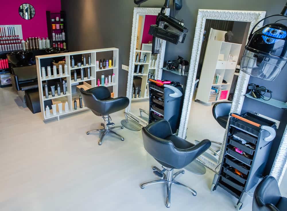 Empty modern hair salon decorated with bold colors using the latest hair care products and equipment.