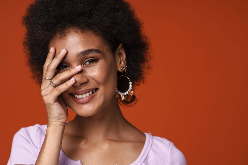 Young African American female after getting a bond realignment treatment to strengthen hair follicles.