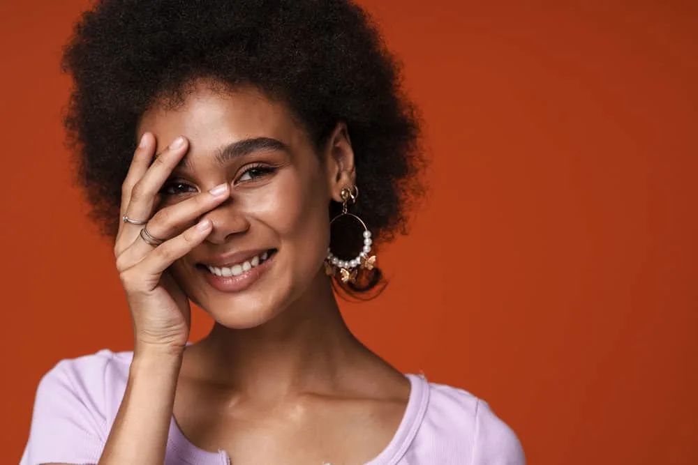 Does Olaplex Have Protein? How Much Protein Does It Have? 1 Young African American female after getting a bond realignment treatment to strengthen hair follicles.