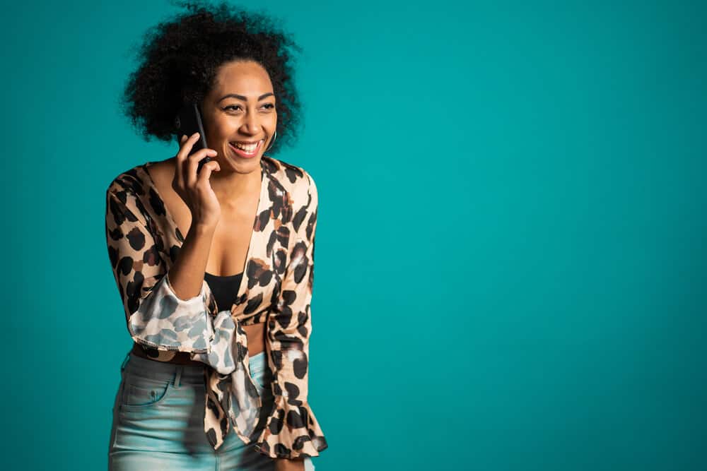 Cute black girl on the phone to a friend about getting the wrong haircut from a professional stylist. 