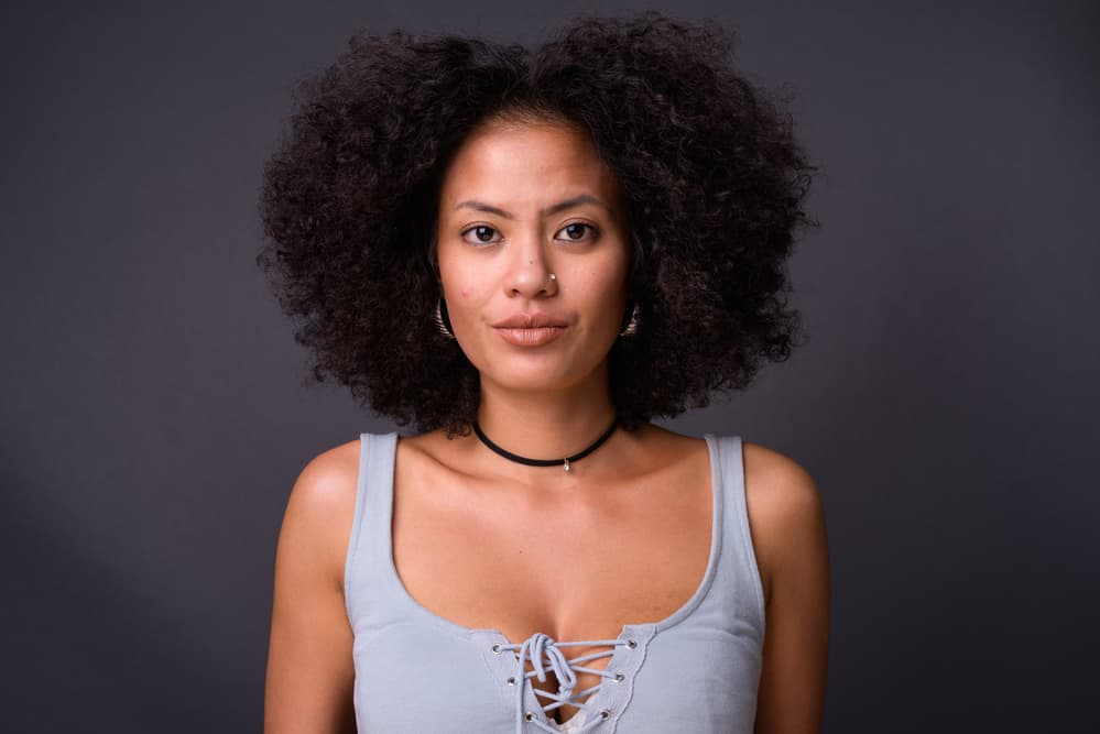 Young multi-ethnic African American woman with healthy hair trimmed into a wolf-cut hairstyle.