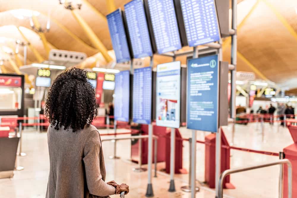 A black girl wants to bring aerosol hairspray in her toiletries bag but is concerned about accidental discharge.