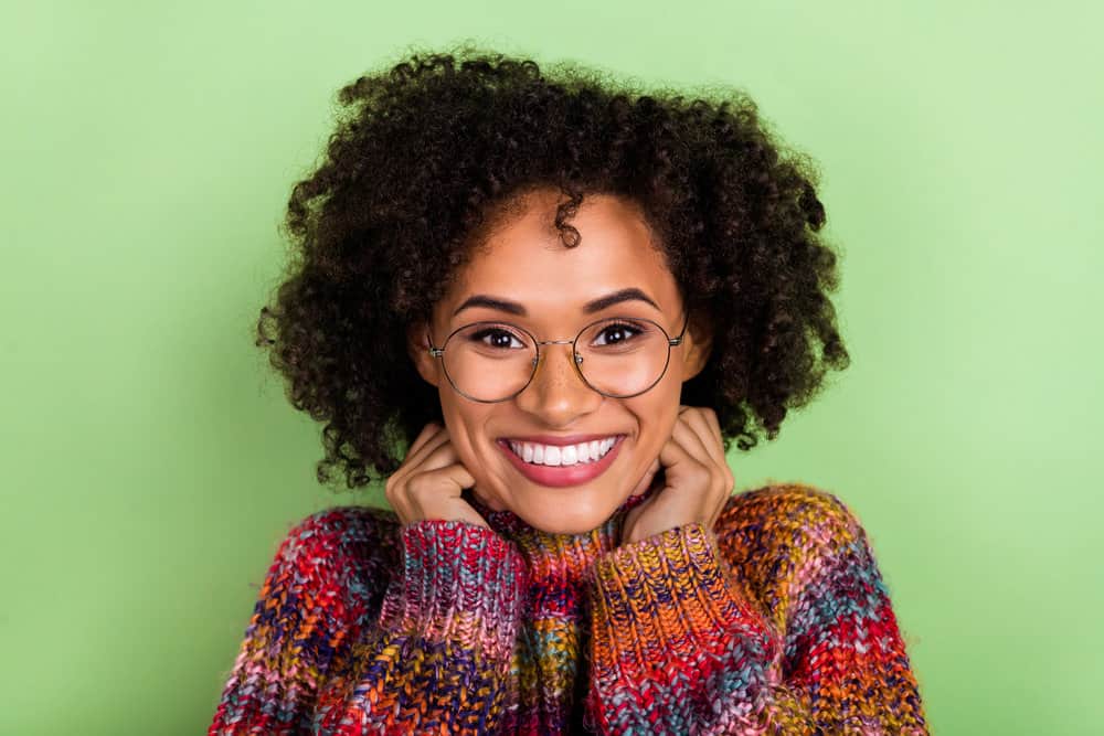 Gorgeous young woman with dark brown permanent hair color on her healthy hair strands.