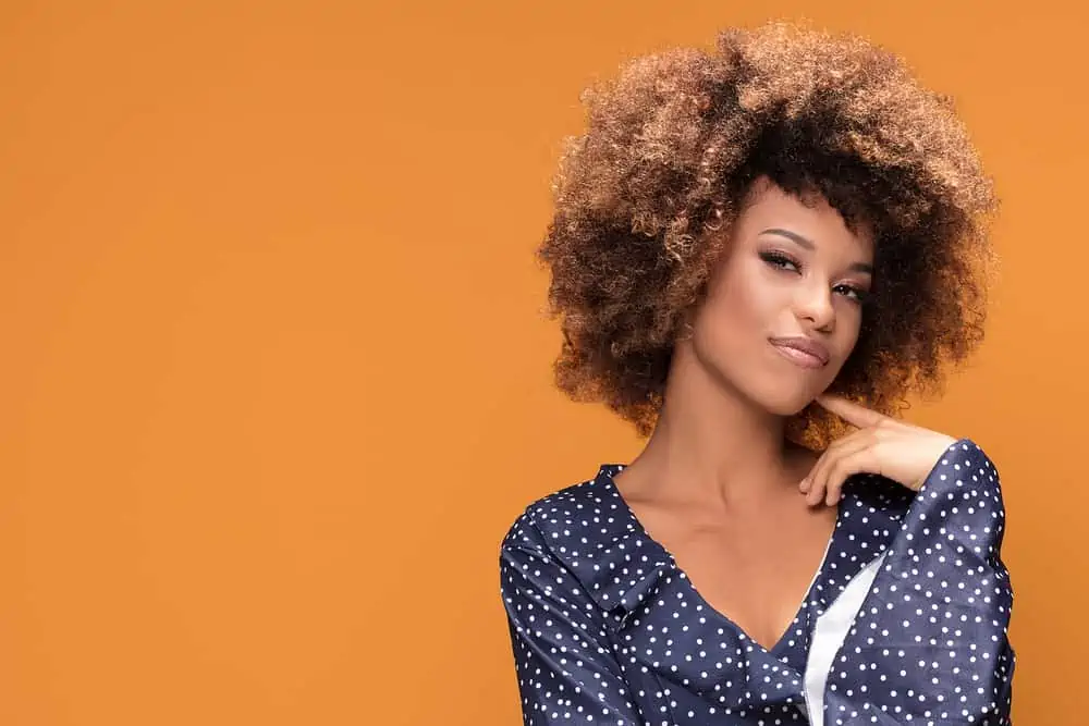 How Long Does Splat Hair Dye Last? How to Make It Last Longer 9 Fashionable young black girl wearing a dotted dress with medium brown curls dyed with Splat beach.