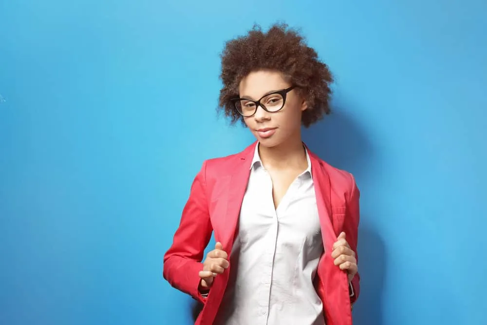 African American female with curly hair cuticles after using a moisturizing hair mask on her medium-brown hair.