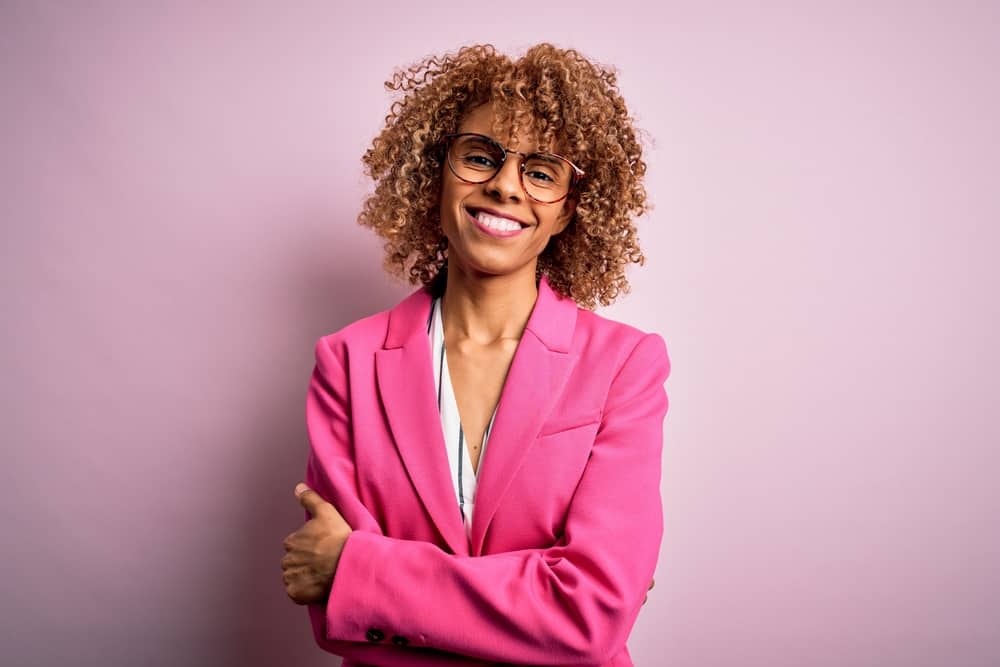 African American lady with brownish blonde hair color from using permanent hair dye chemicals.