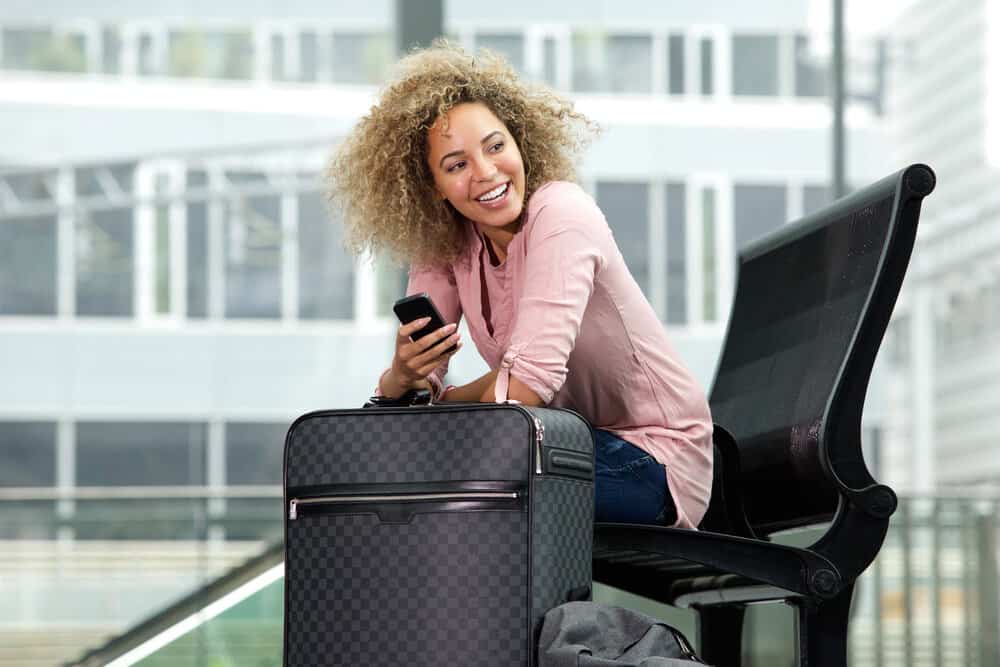 A young black girl holding her hand-carry luggage with her favorite clippers in it approaches a TSA officer.