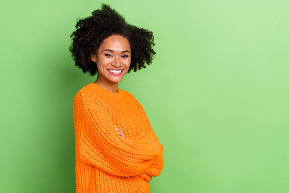 African American female recently dyed her previously blond hair back to its original hair color.