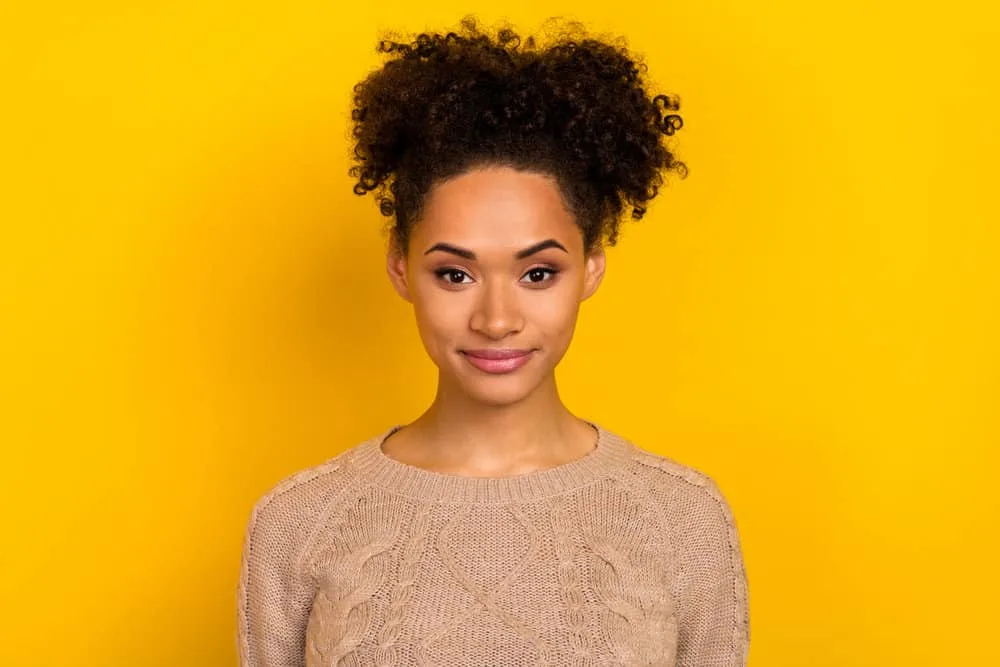 Why Does My Hair Grow Uneven? How to Fix Uneven Hair at Home 2 Adorable young black woman with curly hair after taking hair growth supplements for several months.
