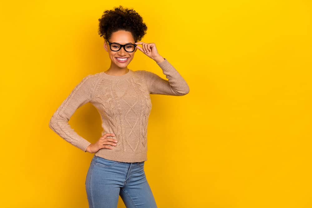 African American female with hair follicle damage on her dark brown kinky natural hair.