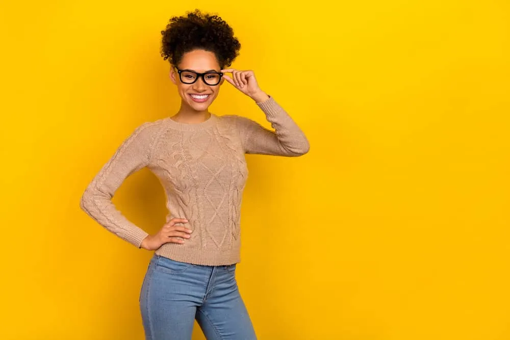 Why Does My Hair Grow Uneven? How to Fix Uneven Hair at Home 6 African American female with hair follicle damage on her dark brown kinky natural hair.