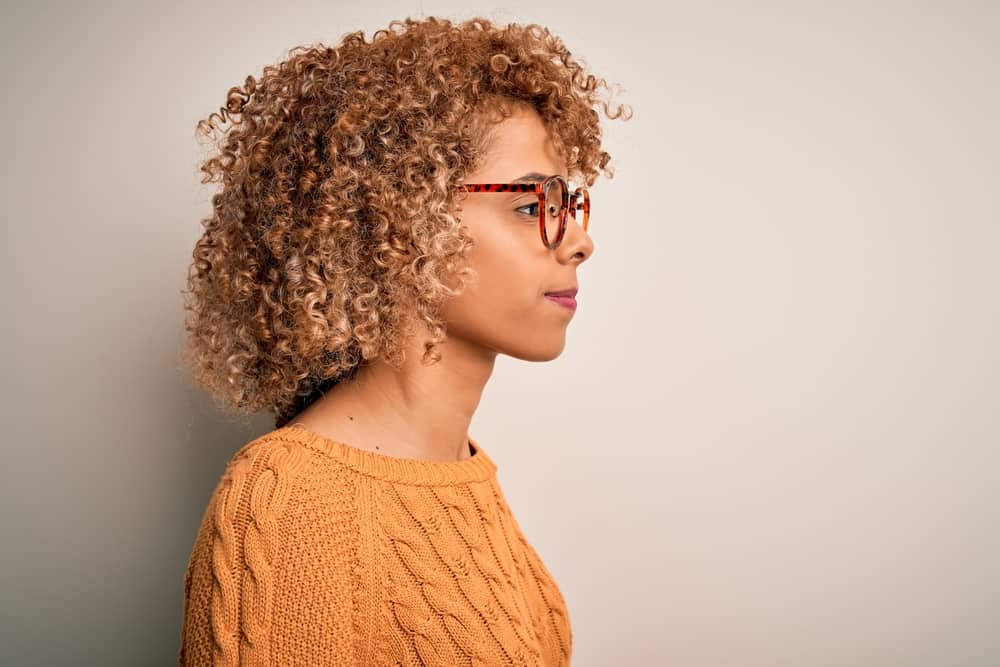 Young black girl wearing a semi-permanent color made from natural ingredients on her 3C curly hair type.