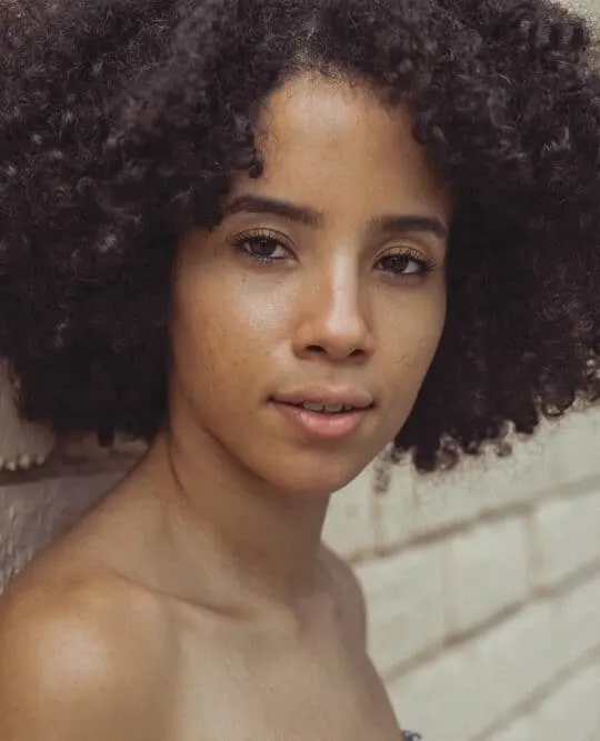 Light skinned black girl wearing naturally curly hair