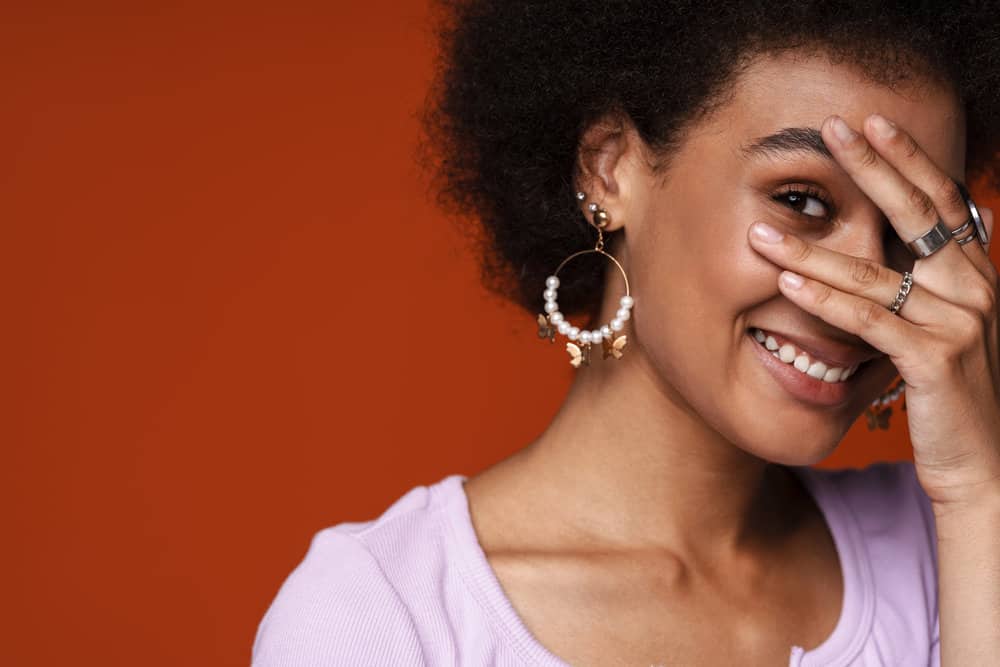 Young lady that's smiling after getting a bond realignment therapy to strengthen hair follicles.