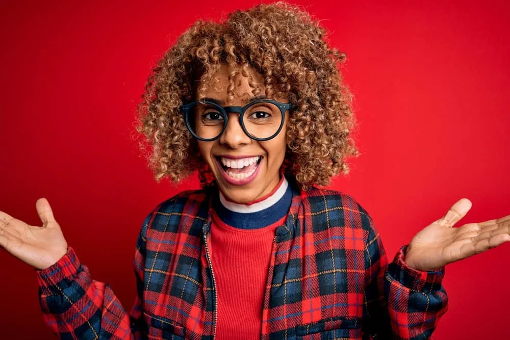 Does Bleaching Your Hair Make It Thinner? Can You Fix Thinning? 7 Young African American woman that had virgin hair that wasn't previously chemically treated until now.