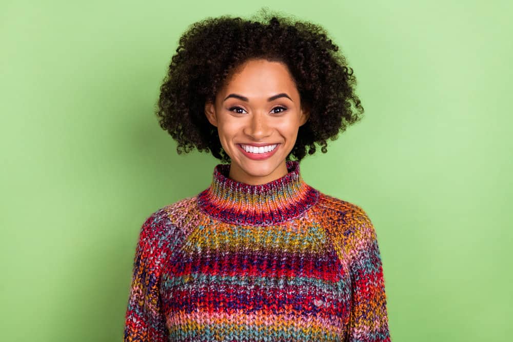 African American female recovering from hair cuticle damage after incurring problems from bleached hair.