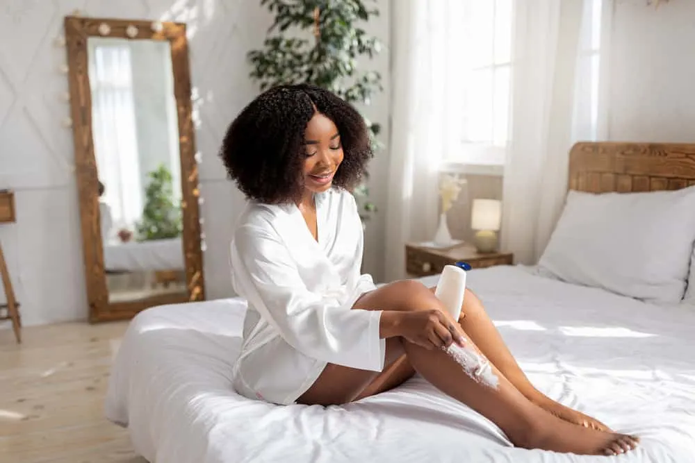 Why Does My Leg Hair Grow So Fast? How to Get Rid of Leg Hair 5 Dark-skinned African American female with body hair using a common hair removal method to shave legs.