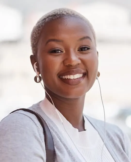 Cute African American female with a light-brown skin tone and a TWA hair length that requires minimal styling.