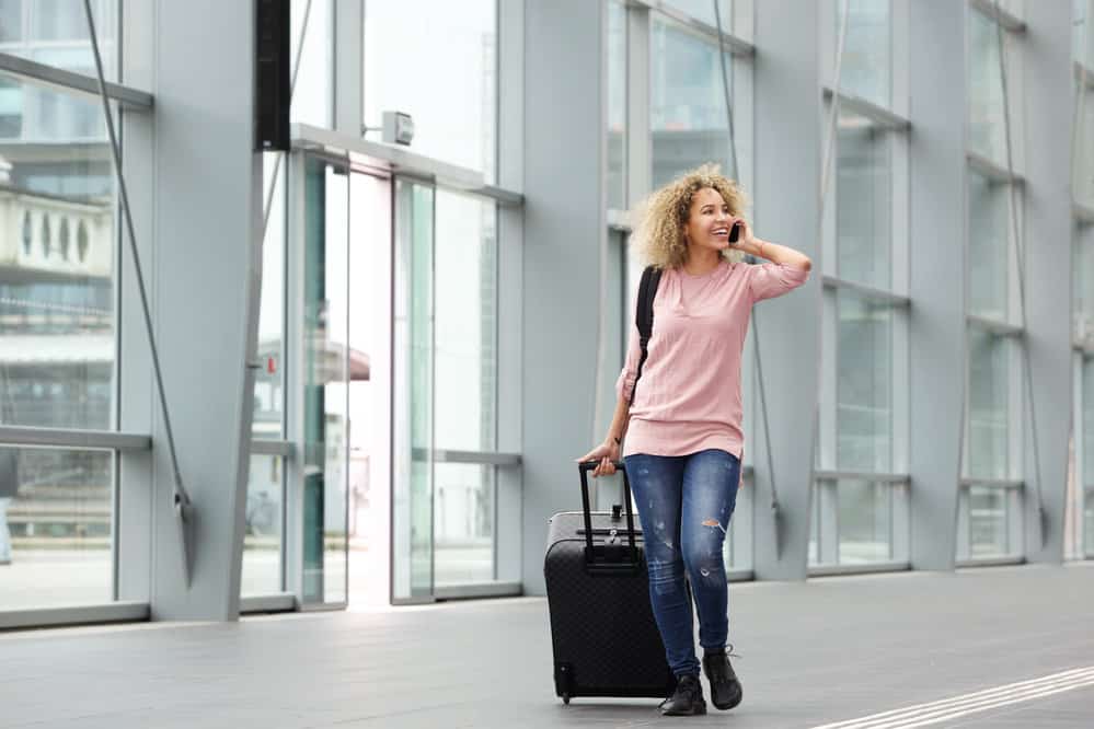 A young black girl wearing jeans approaches a TSA officer with her favorite clippers in her hand-carry luggage.