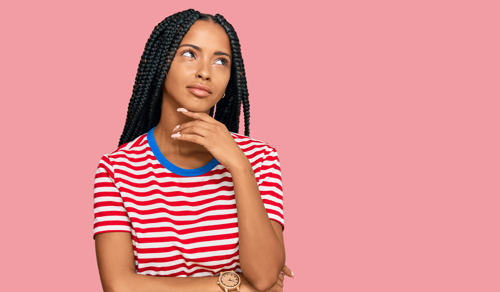 Cute black girl with her hair worn in goddess braids - one of the most popular African hairstyles.