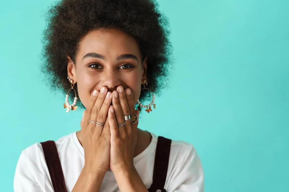 Why Won’t My Hair Take Color? How to Fix the Problem 7 A young black girl after using a clarifying shampoo and conditioner to restore moisture to her kinky strands.
