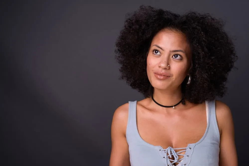 How Long Does It Take For Roots To Grow Out: Growing Out Natural Hair Color 4 An African lady with chemically treated hair showing off her root touch-ups after going to a professional colorist.