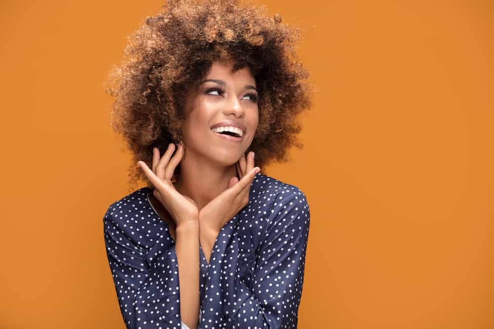 Cute female with a great smile showing off her dark hair after using lightening bleach on the tips.