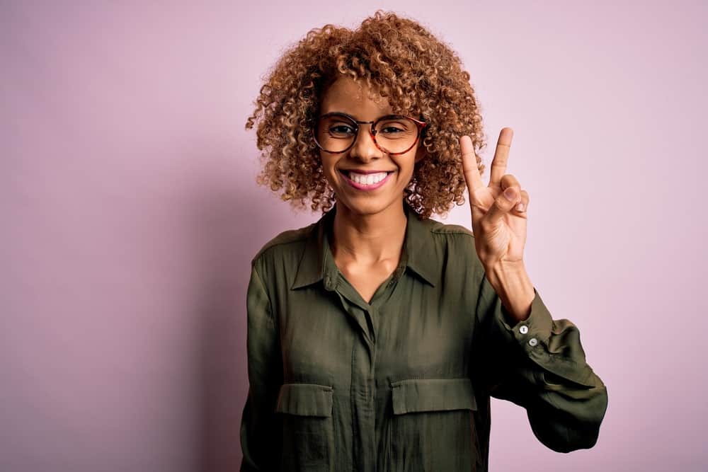 Young beautiful black girl with bouncy curls after using aloe vera gel and two different sulfate-free shampoos.