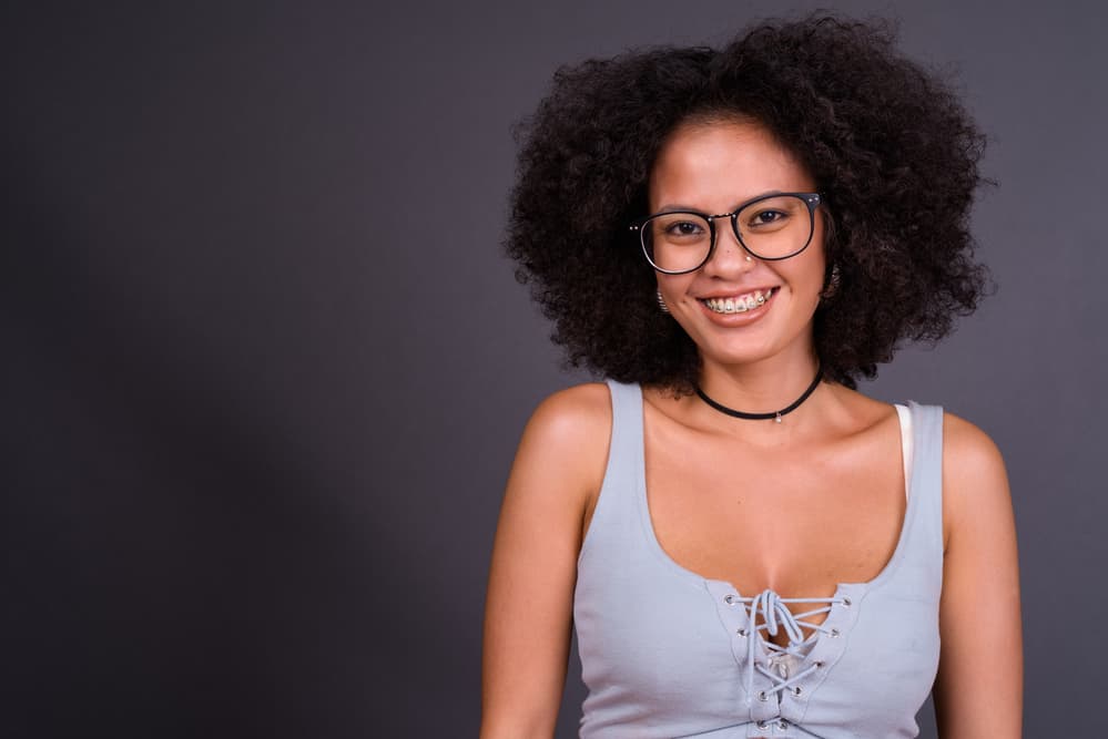 Cute African American with natural grey color that was recently dyed dark brown due to root growth.