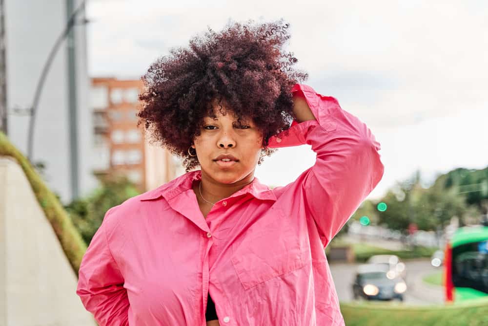 A young black girl after blending red permanent color with dark brown hair - her previous color.