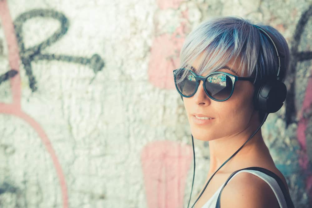 A gorgeous young lady with a pale complexion and light brown hair who is sporting a dark blue subtle tint.