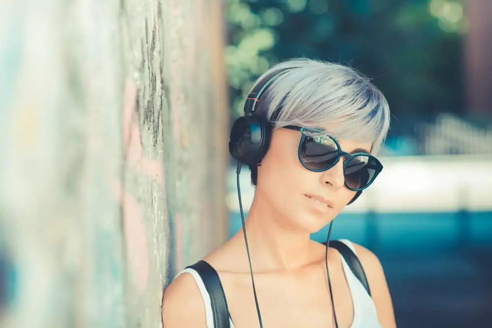The Best Blue Hair Dyes for Dark Hair Plus Alternatives 10 A happy lady wearing 1C hair strands with a semi-permanent color on yellow skin tones.