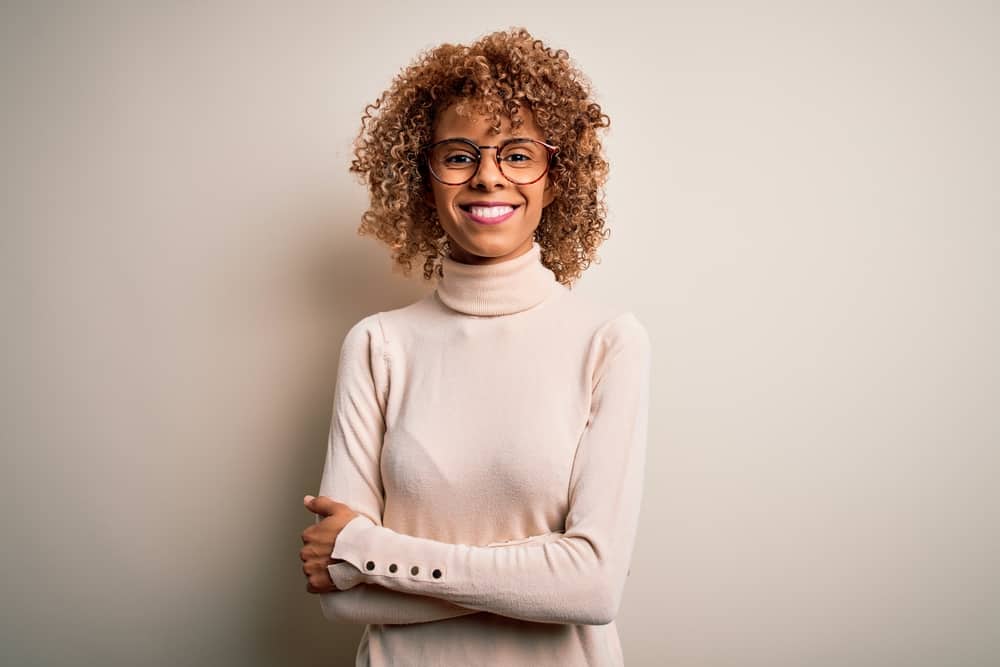 Young African American lady with reddish-brown hair dyed a lighter color with Clairol Natural Instincts.