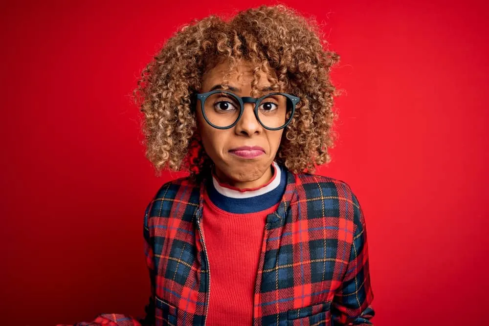 Does Bleaching Your Hair Make It Thinner? Can You Fix Thinning? 4 Young beautiful African American woman with her hair bleached a very light color that looks platinum blonde.