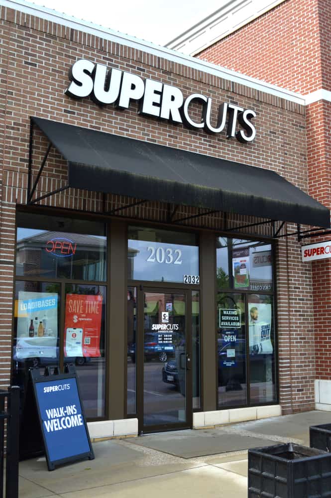 Supercuts hair salon advertising their tea tree experience, gray blending services, and kids haircut.