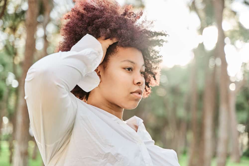 Beautiful African American female with naturally dark brown hair after getting a salon hair color treatment.