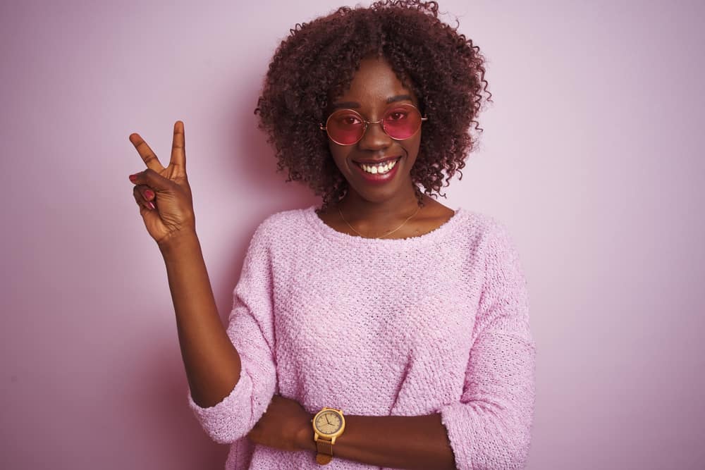 Young black girl wearing a combo wig made from animal hair and synthetic fiber.