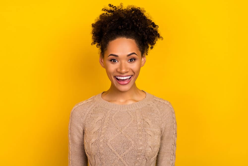 African American female with healthy hair growth after struggling with thinning hair and split ends.