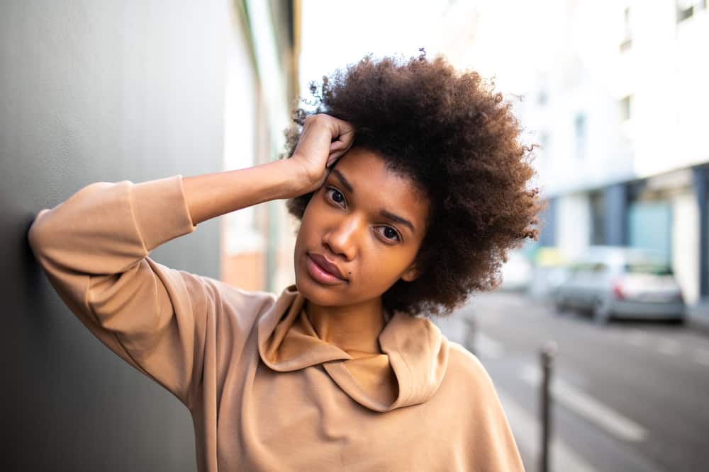 African American female with tangled hair knots and split ends on her 4C kinky natural hair.