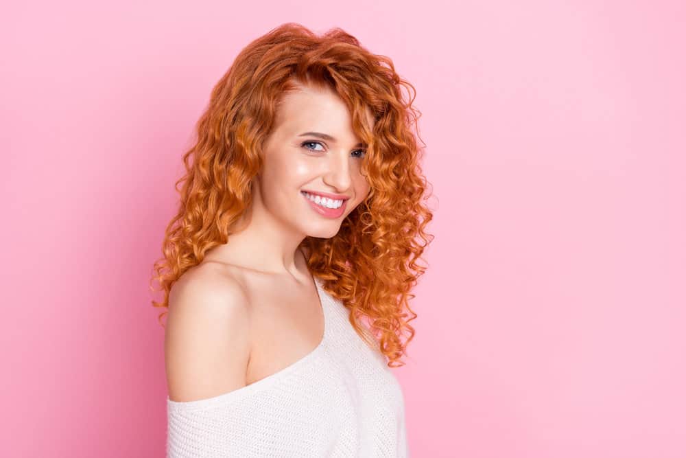 White lady with a great smile after styling her previously tangled hair with black people's hair products.